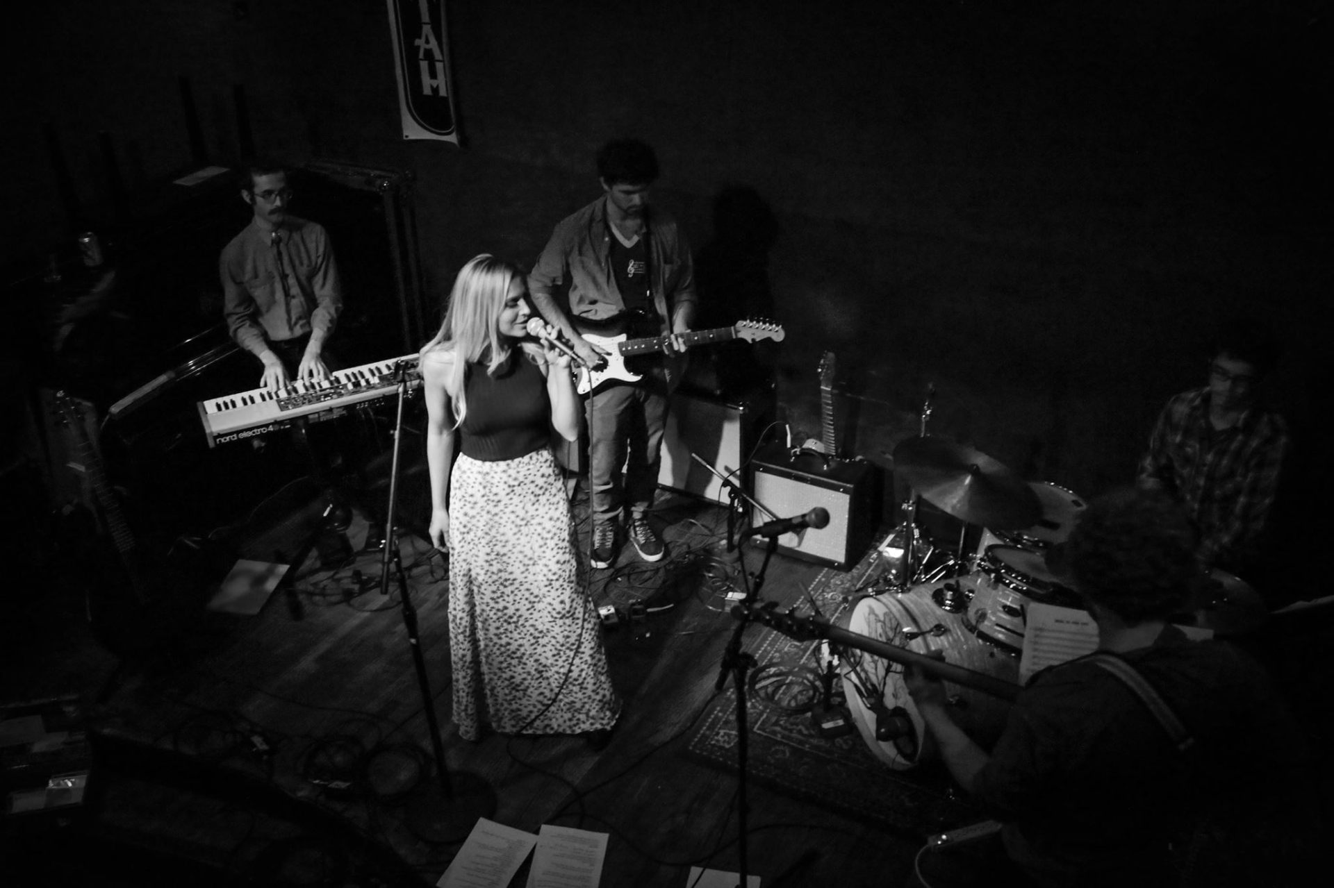 Christine performing live with a band, black and white