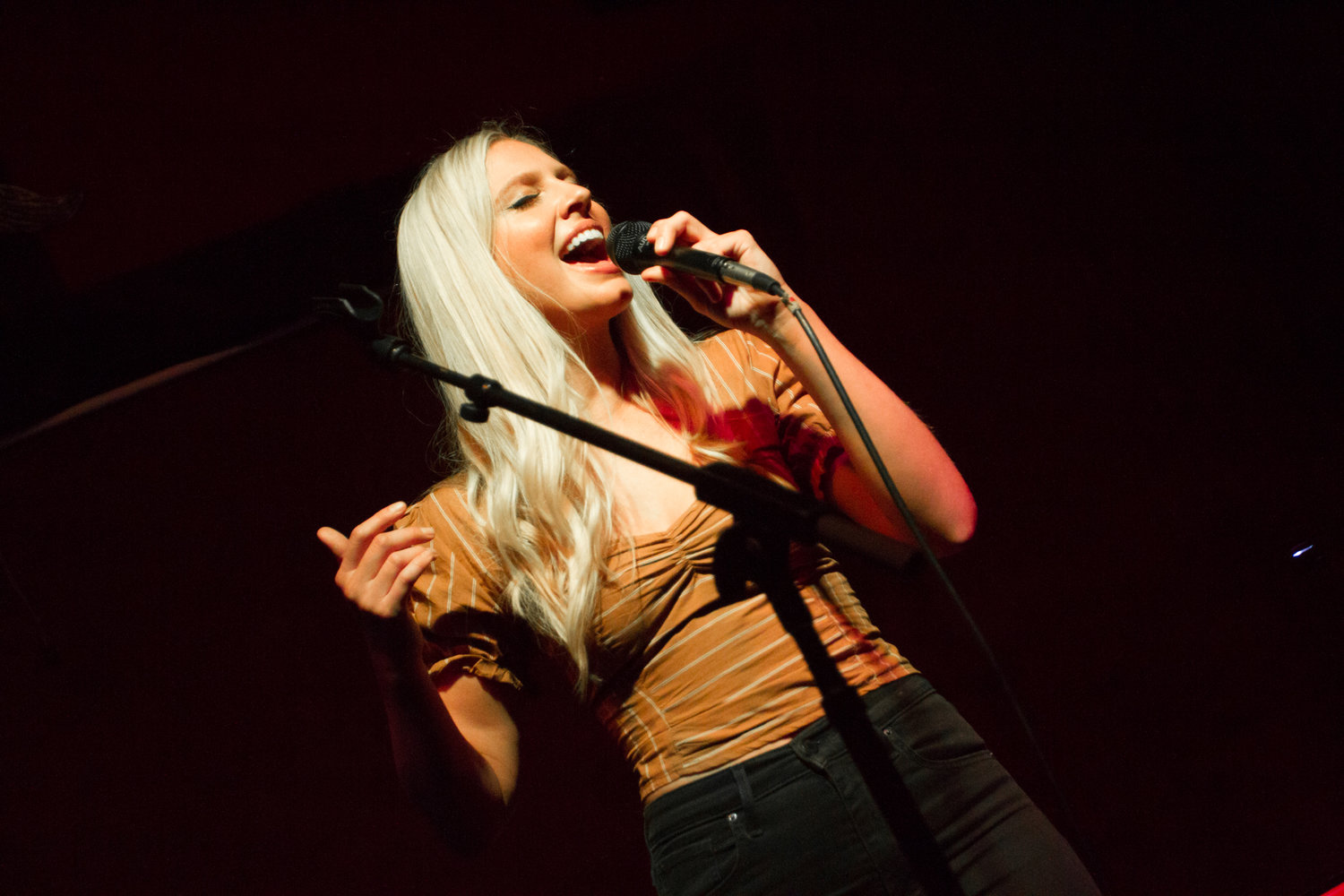 Christine singing into the microphone